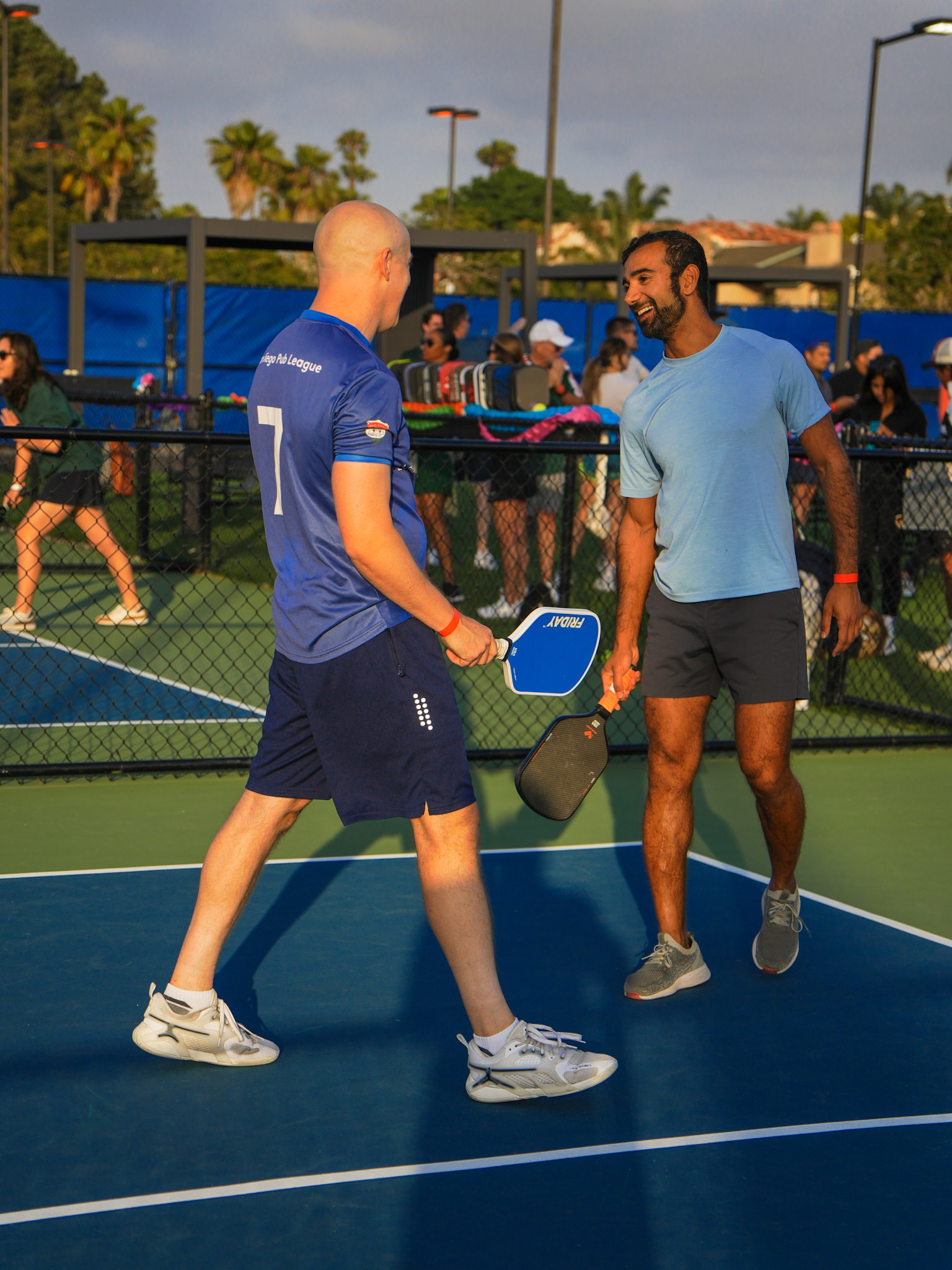 Pickleball players competing in an organized match at outdoor courts